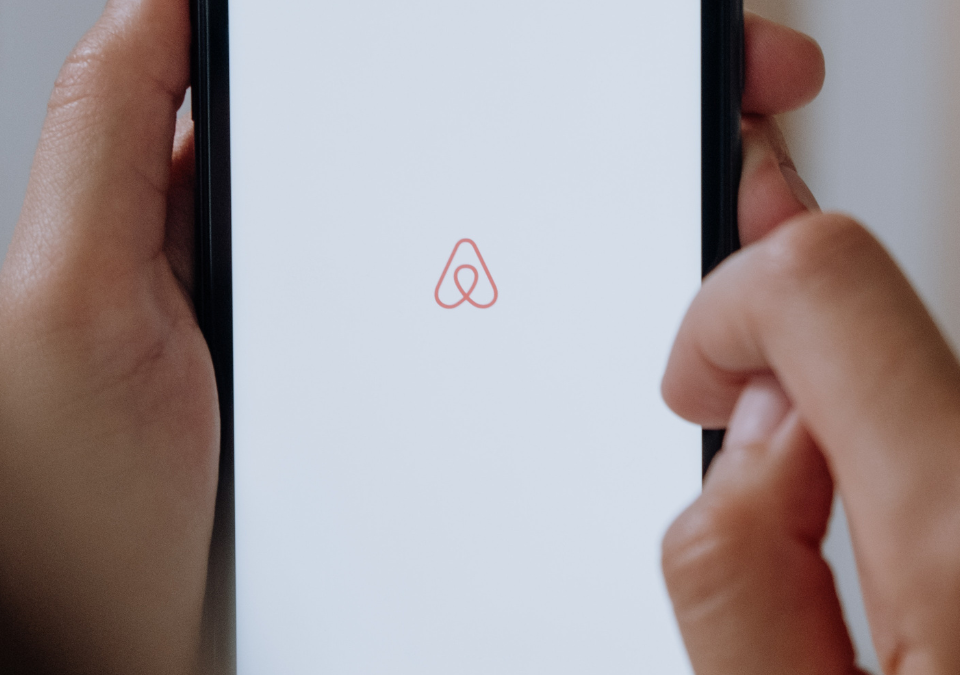 Phone screen with Airbnb logo